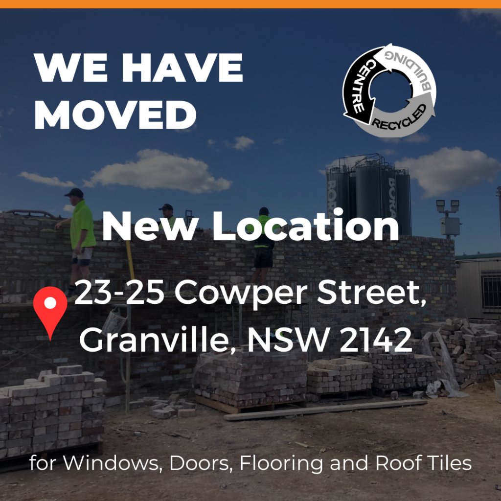 Construction site with a "We Have Moved" notice for a new location at 23-25 Cowper Street, Granville, NSW 2142, offering windows, doors, flooring, and roof tiles.