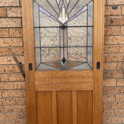 Vintage wood door with stained glass. Art Deco style door with geometric glass design. Interior design.